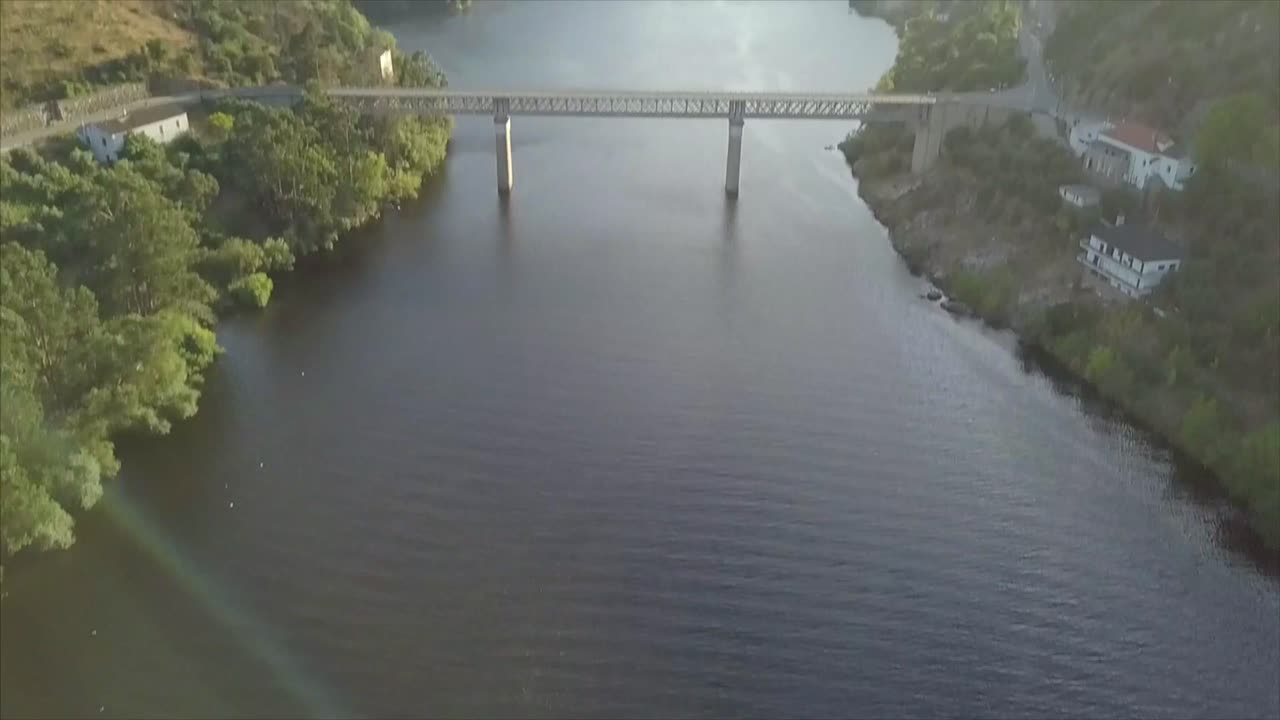 Boat On A River, Aerial Footage revile bridge.