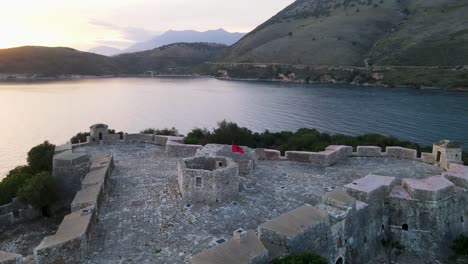 aerial orbit, porto palermo castle, a majestic fortress on the albanian shore, comes into view