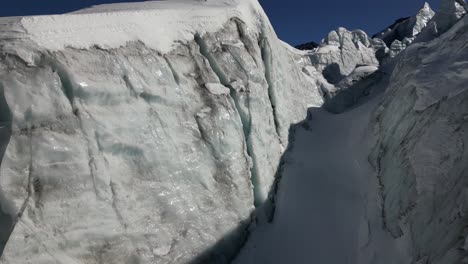 aerial view, icy facade of a glacier, in winter, swiss alps mountains