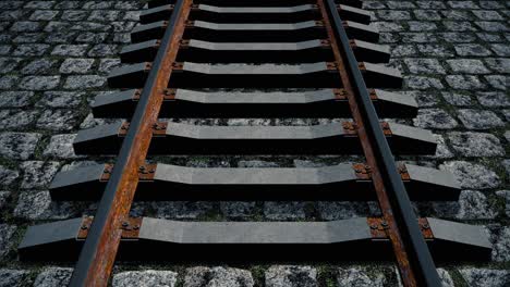 una vista aérea sobre una vieja vía ferroviaria oxidada colocada sobre adoquines - bucle sin costuras