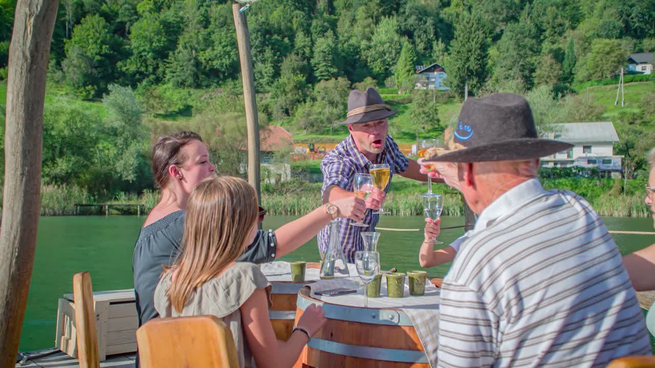 adventurous and joyful raftsmen and family drink during raft ride, Muta