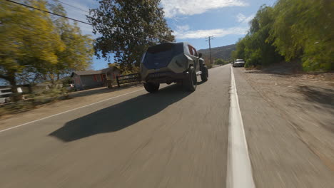 cinematic fpv shot of a tactical police suv driving along a road