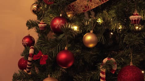 beautifully decorated christmas tree adorned with red, gold, and candy cane ornaments, glowing lights, and festive ribbons, capturing the warmth of the holiday season