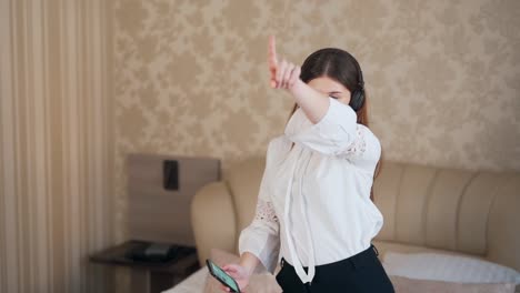 young girl dancing on the bed in headphones