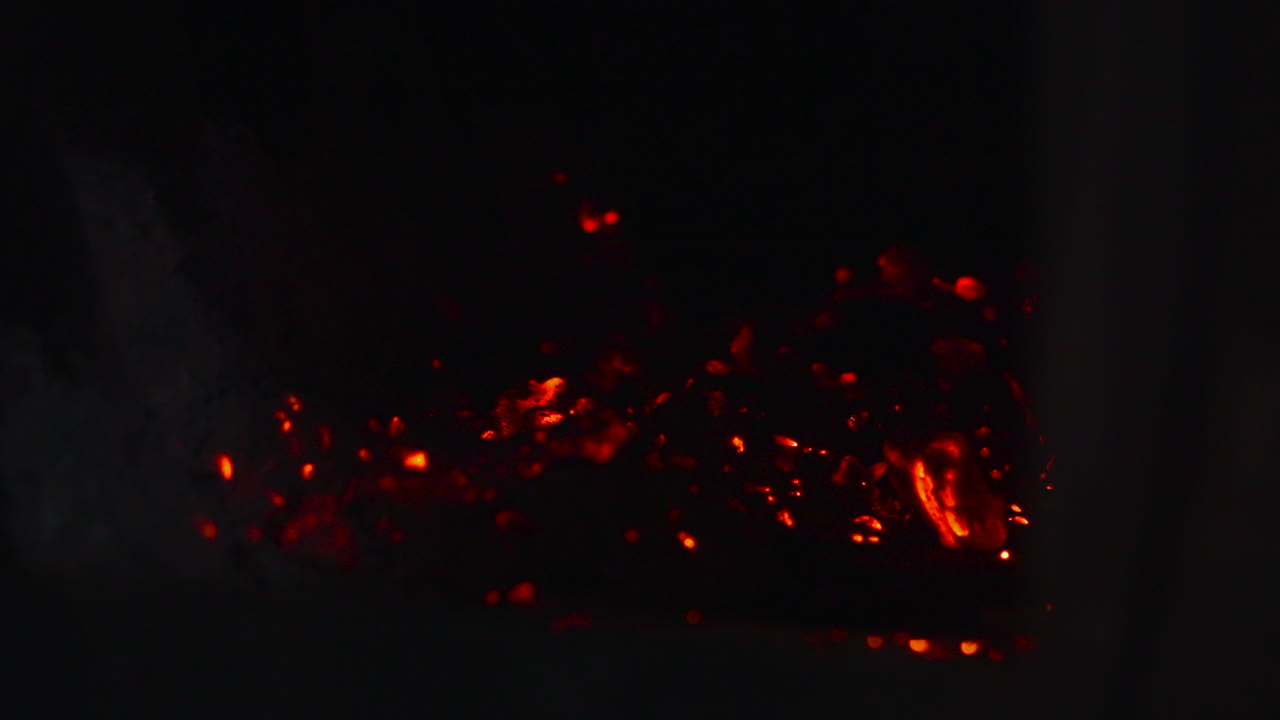 Sparking Embers Scatter Across Dark Hearth, Tiny Red Streaks Lift And Fall, Dynamic Motion With Smoky Trails,. Media