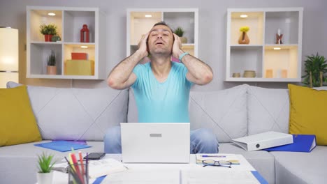 Home-office-worker-man-looks-at-camera-with-happy-and-smiling-face.