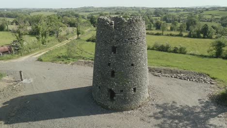 Ancient-Celtic-Round-Tower-In-Ireland---aerial-drone-shot