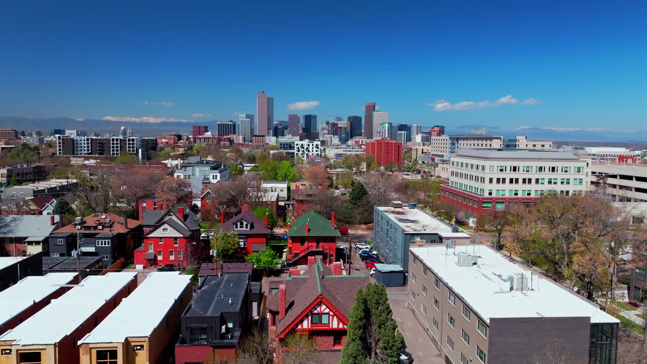 City Park neighborhoods Denver spring summer aerial drone Colorado Front range Lodo Downtown cityscape Rocky Mountain street cars tall buildings skyscrapers sunny blue sky upwards motion