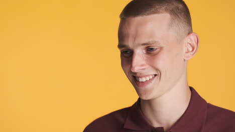 young man smiling and looking aside