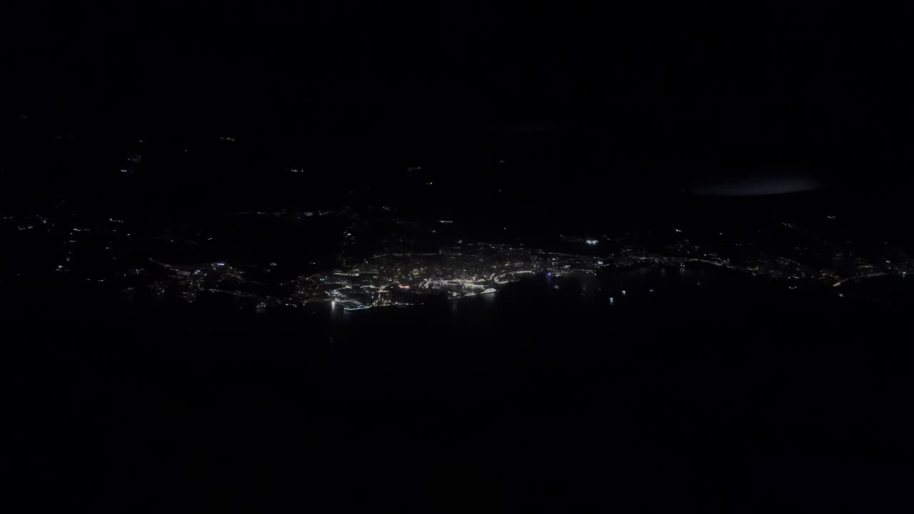 View from an airplane window of the aircraft flying at night