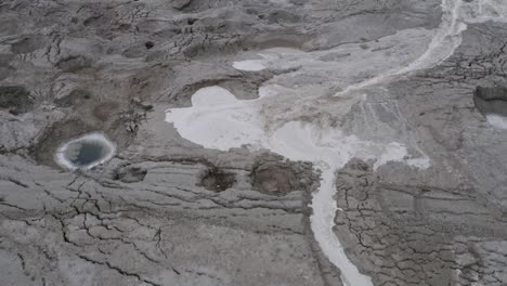 flood-stream-by-sinkholes,-dead-sea-Israel,-tilt-up-shot