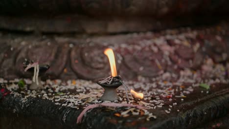 candles at a buddhist temple in bhaktapur in nepal, close up of prayer candles for praying in the ancient city of bhaktapur, used in a spiritual and holy sacred place of worship