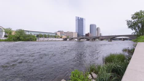 Slow-motion-shot-of-the-Grand-river-flowing-through-downtown-Grand-Rapids,-Michigan