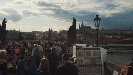 tourist walking on the charles bridge in old town prague, czech republic