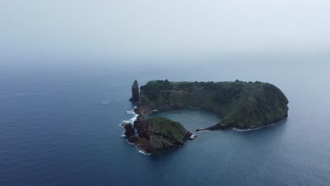 Foggy-ocean-aerial:-Vila-Franca-Islet-on-Sao-Miguel-Island,-Azores