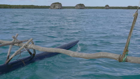 outrigger of kanak pirogue sailing on upi bay