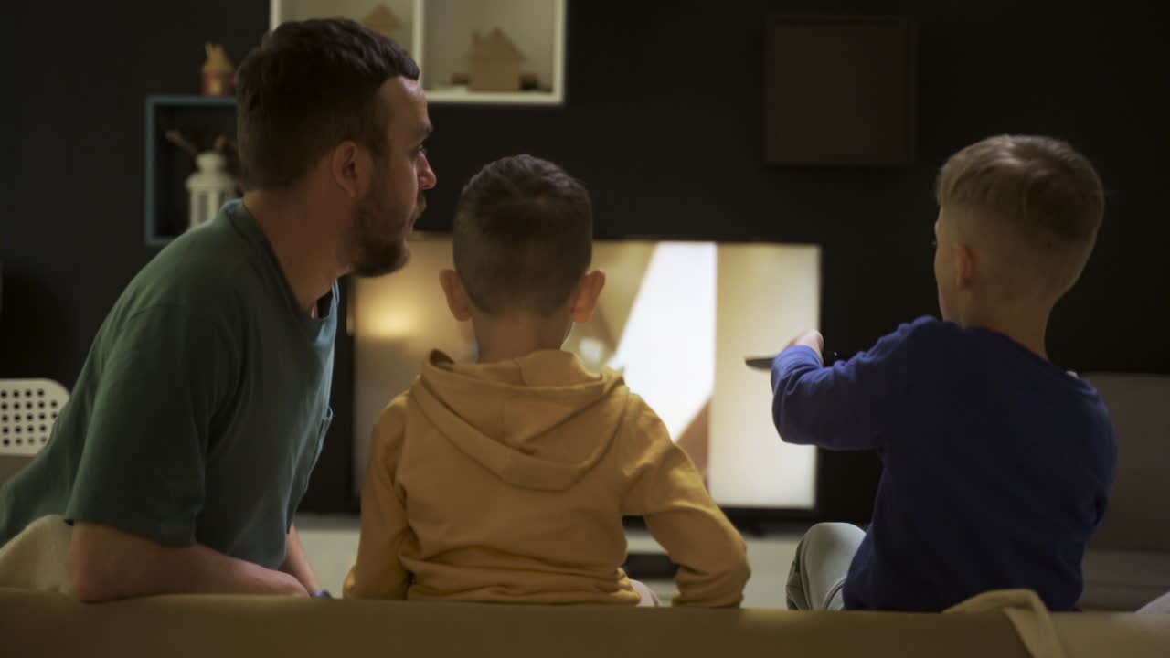 Family sitting on the sofa at night