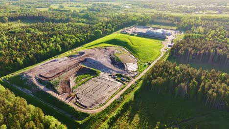 aerial sunrise footage of landfill infrastructure near forest in jelgava region