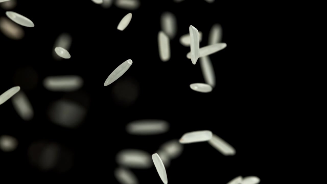 Slow Motion of White Rice Grains Falling Against Black