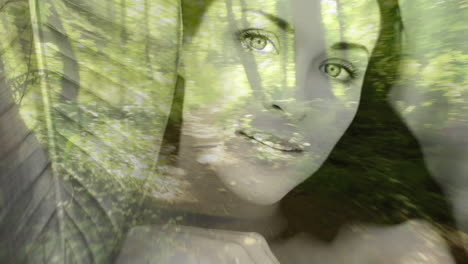 rostro de la mujer sobre la animación del camino del bosque con la luz del sol filtrando a través de los árboles
