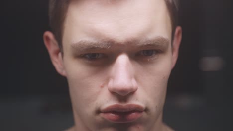 closeup face of a young man grimacing