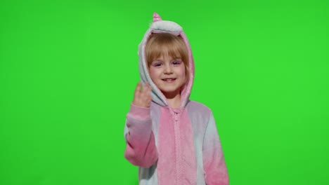 Little-blonde-child-girl-smiling,-dancing,-celebrating-in-unicorn-pajamas-costume-on-chroma-key