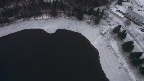 bottom-up view of a drone on snowy wooded nature in winter, with a foggy horizon and mountains. vír, czech republic
