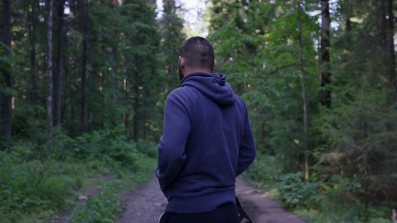 Man Walking Through Forest