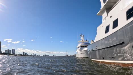 boats docked with city skyline in background