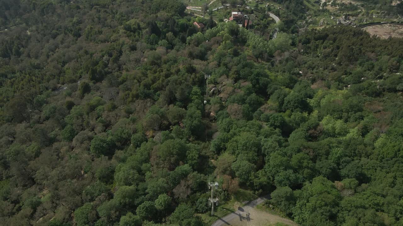 Penha cable car ride above lush forest, Guimarães, Portugal - Aerial