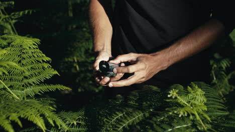 man using a compass in nature