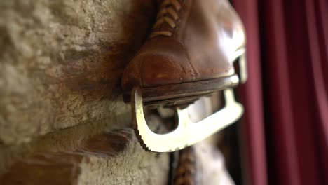 old brown leather antique ice skating shoe on historic wall