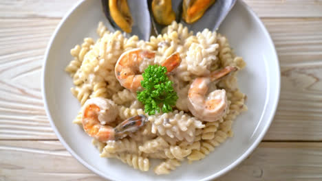 spiral pasta mushroom cream sauce with seafood - italian food style