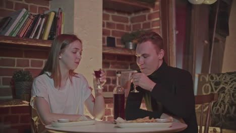 couple enjoying a drink and dinner in a cafe