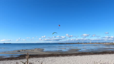 paragliding and paramotoring over a beautiful beach