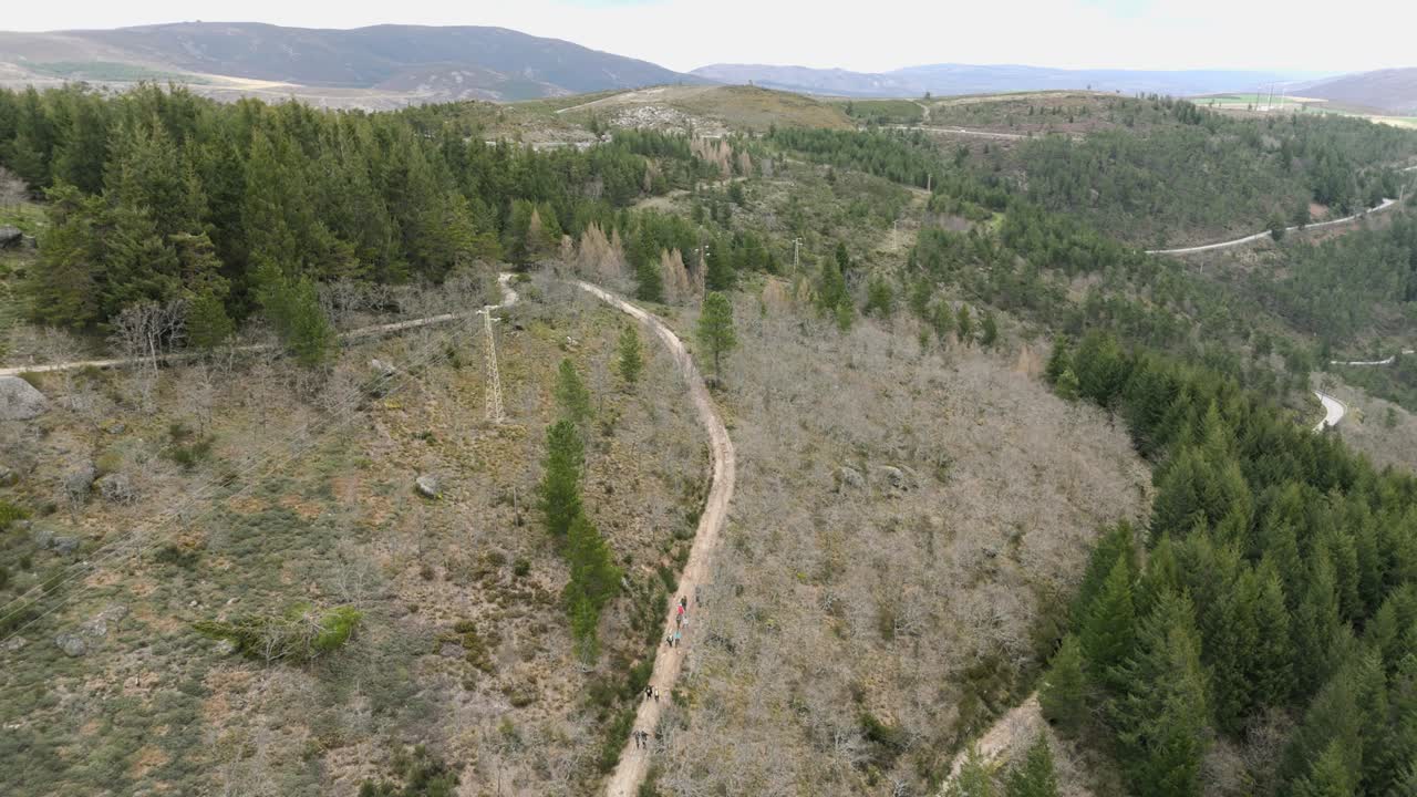 Aerial shot of hikers on a mountain path in Manteigas Portugal near Serra da Estrela under clouds