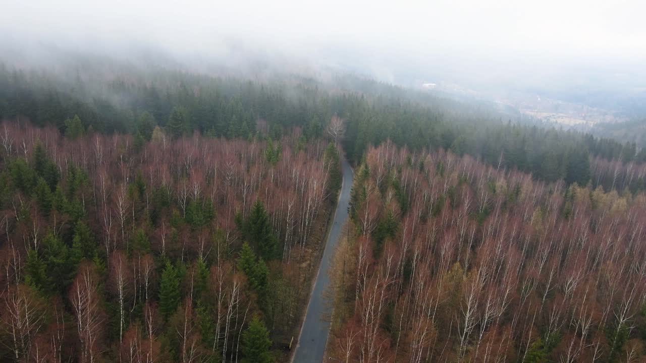Aerial Drone Flying Through White Rainy Fog To Show Mountain Road
