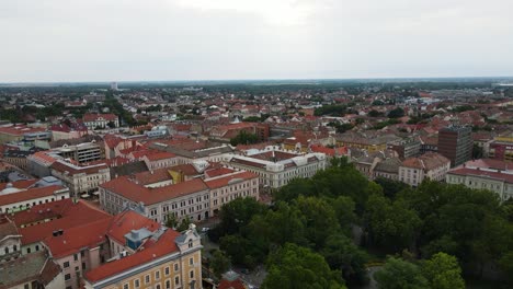 Flyover-above-red-roofed-buildings-of-Szeged,-Hungary
