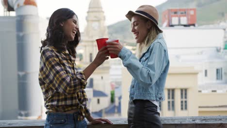 young adult friends hanging out on a rooftop