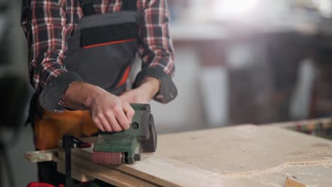 close-up of male hands working with belt sander