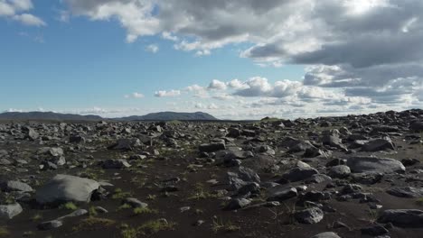 Rock-field-in-generic-Iceland-nature-landscape,-low-aerial-forward