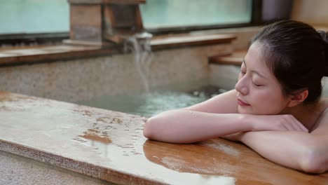 japanese girl takes a rest lying down on poolside