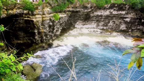 dolly rack focus of stunning mystical blue water and sandy beach cove of broken beach bali, indonesia