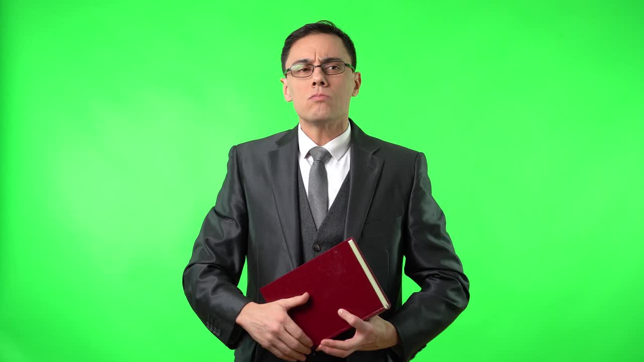 Man in Suit with Red Book on Green Screen