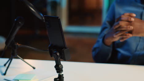 smartphone on holder used by influencer