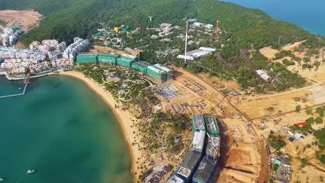 aerial view of the vinhomes construction site on phu quoc island, vietnam, showcasing the ongoing development of a luxury resort designed with santorini-style architecture.