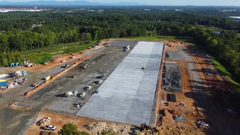 concrete trucks line up to pour concrete at a construction site