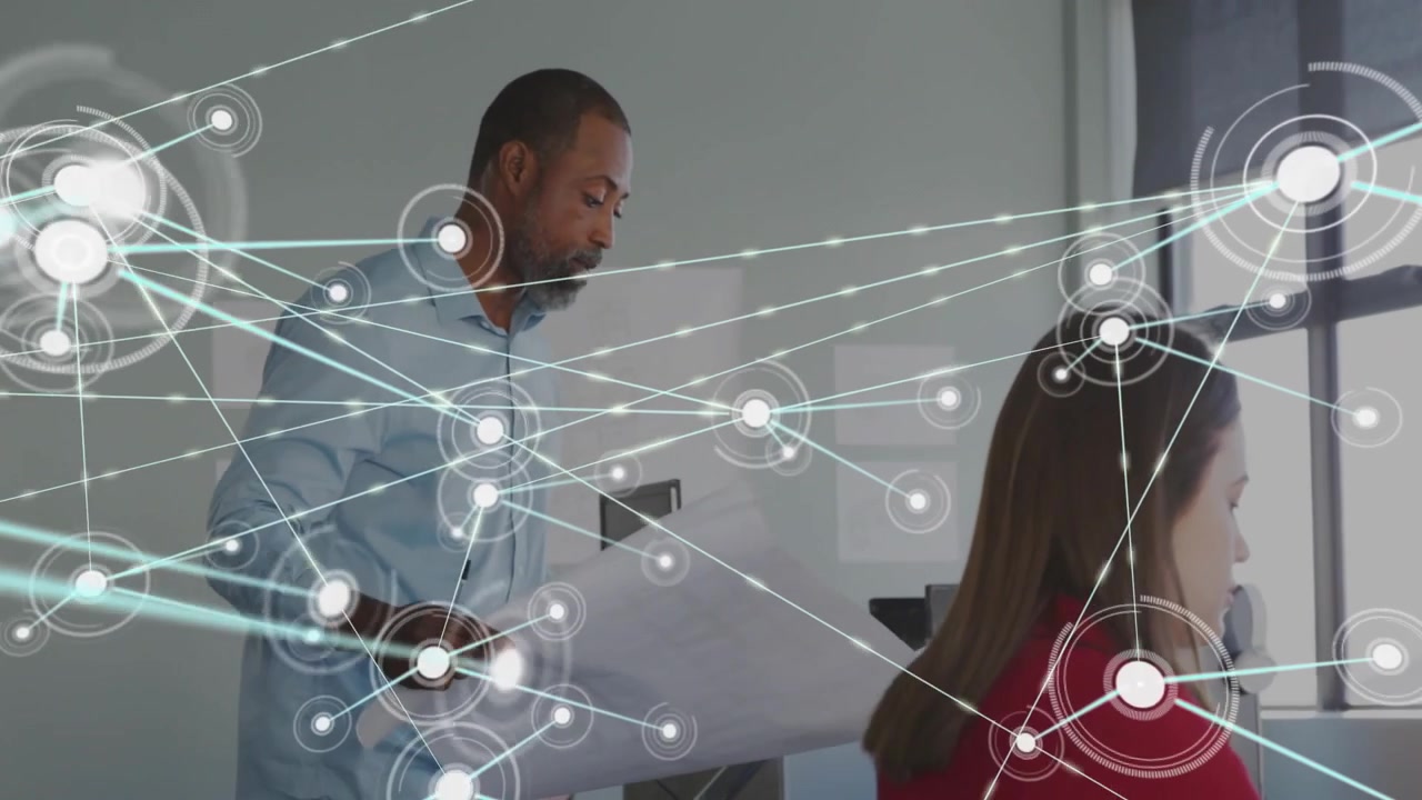 Engineer opening plans and growing animated nodes linking paper designs to computer monitor
