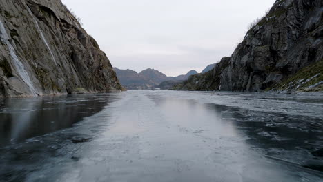 tourist attraction trollfjord in northern norway - low aerial over floating ice