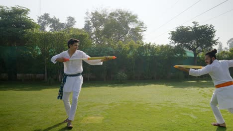 indian men playing holi with water gun